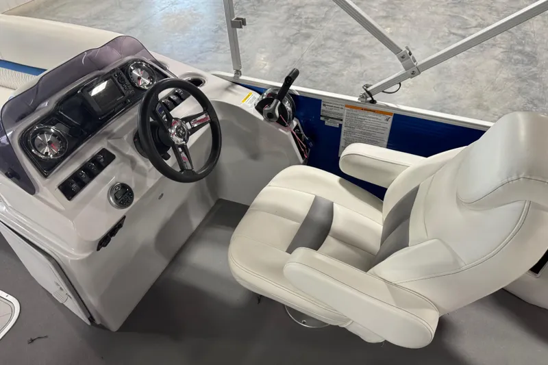 Slide: The Image of Captain's seat and helm of 2019 Sweetwater 2486 boat, featuring steering wheel and controls. - 10