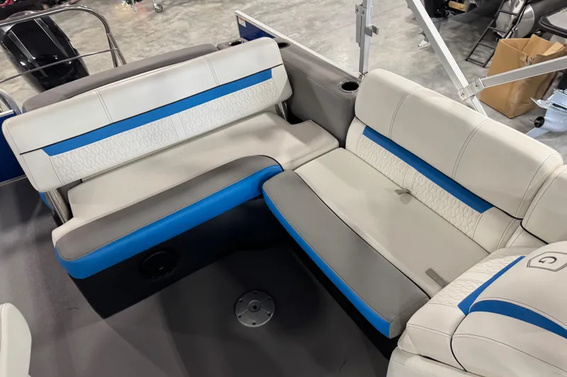 Slide: The Image of 2019 Sweetwater 2486 boat interior with white and blue cushioned seating. - 13