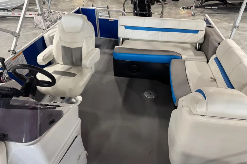 Slide: The Image of Interior of a 2019 Sweetwater 2486 boat with white and blue seating. - 14