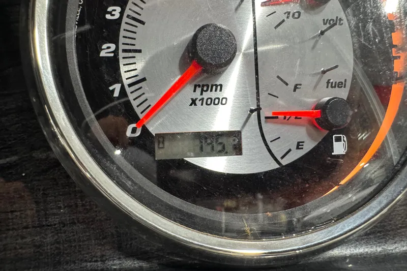 Slide: The Image of Close-up of a 2019 Sweetwater 2486 dashboard gauge showing RPM and fuel levels. - 6