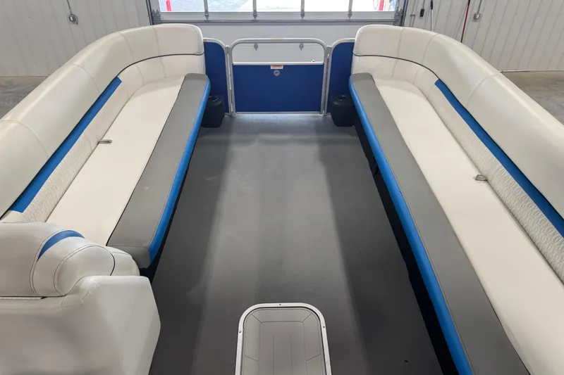 Slide: The Image of Interior of a 2019 Sweetwater 2486 pontoon boat with white and blue seating. - 7