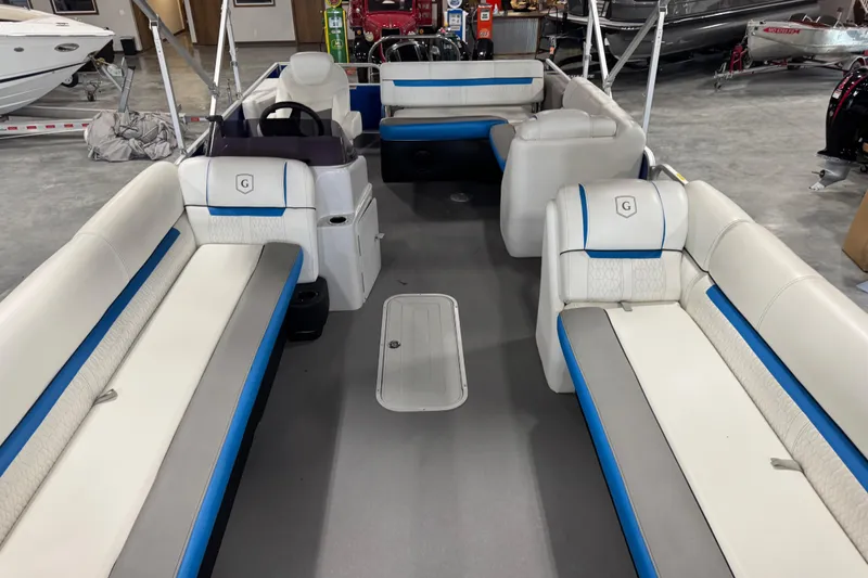 Slide: The Image of Interior of a 2019 Sweetwater 2486 pontoon boat with white and blue seating. - 8