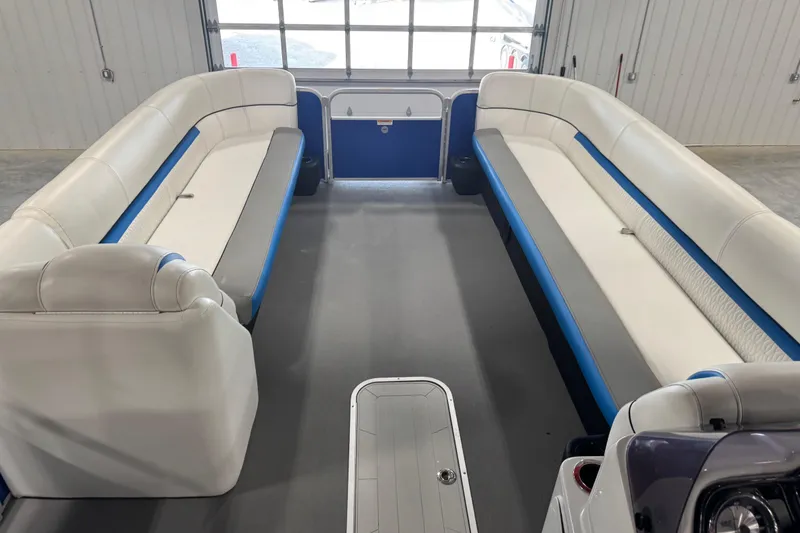 Slide: The Image of Interior of a 2019 Sweetwater 2486 pontoon boat with white and blue seating. - 9