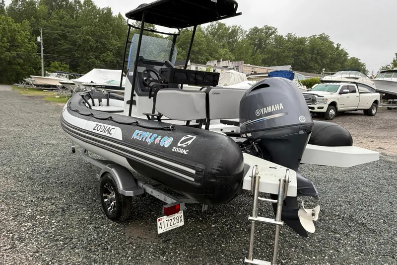 Slide: The Image of 2023 Zodiac Open 5.5 boat with Yamaha engine on trailer in a boatyard. - 5