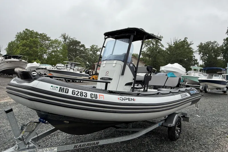 Slide: The Image of 2023 Zodiac Open 5.5 boat on trailer in outdoor storage area. - 6