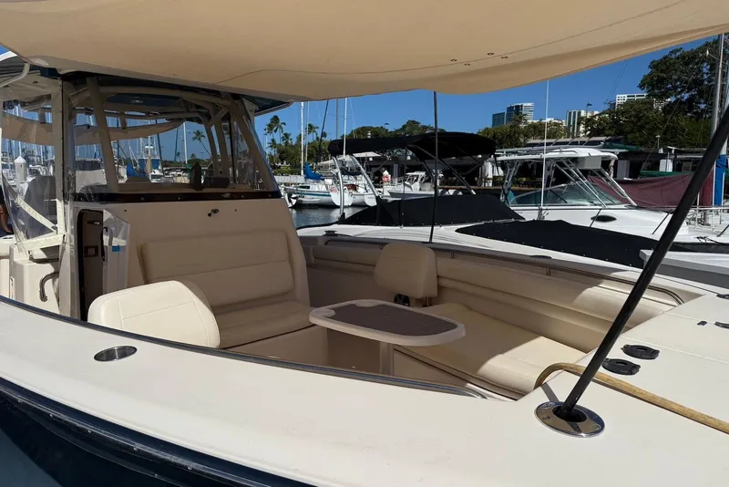 Slide: The Image of 2020 Grady-White Canyon 306 boat with seating area, docked at marina. - 10