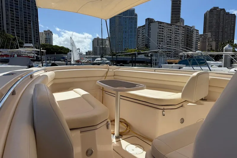 Slide: The Image of 2020 Grady-White Canyon 306 boat interior with seating, docked in urban marina. - 11