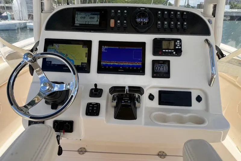 Slide: The Image of Control panel of 2020 Grady-White Canyon 306 boat with navigation and steering features. - 13