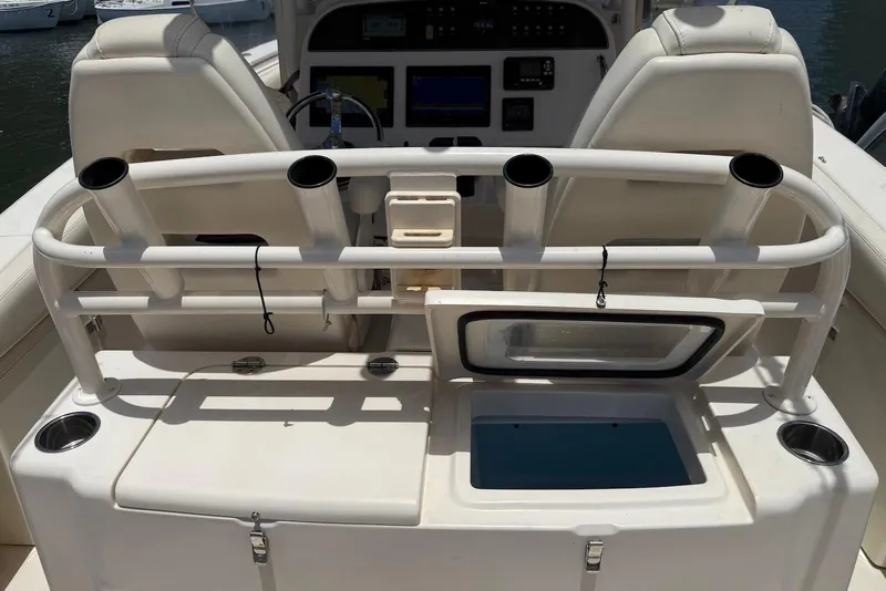 Slide: The Image of 2020 Grady-White Canyon 306 boat interior with rod holders and storage compartments. - 14