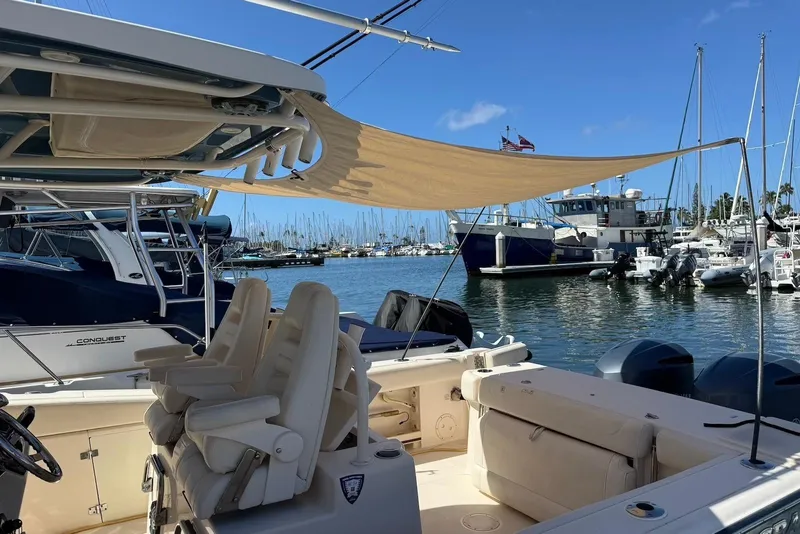 Slide: The Image of 2020 Grady-White Canyon 306 boat docked in a marina with sunshade. - 15