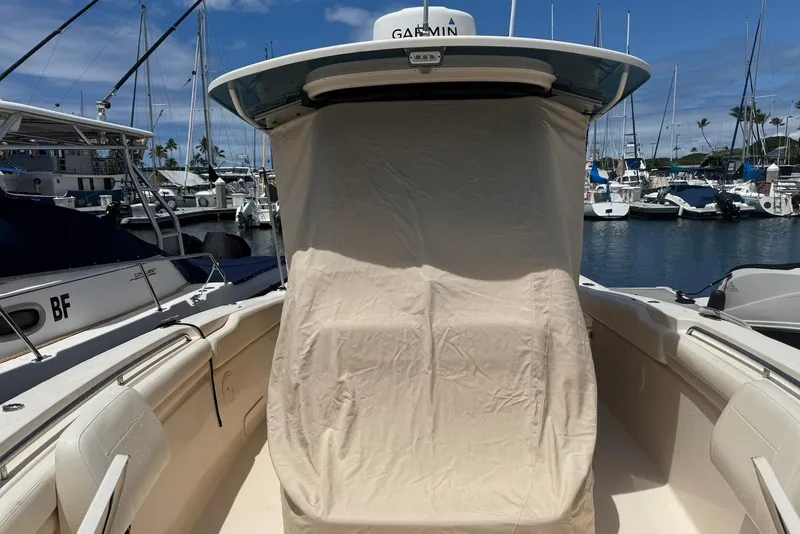 Slide: The Image of 2020 Grady-White Canyon 306 boat docked at marina, covered console, clear sky. - 19