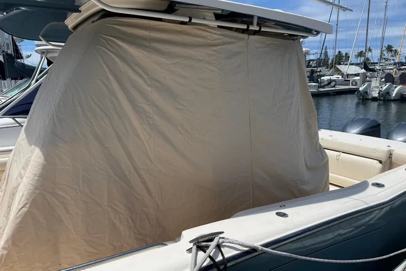 Slide: The Image of 2020 Grady-White Canyon 306 boat with protective cover at marina. - 20