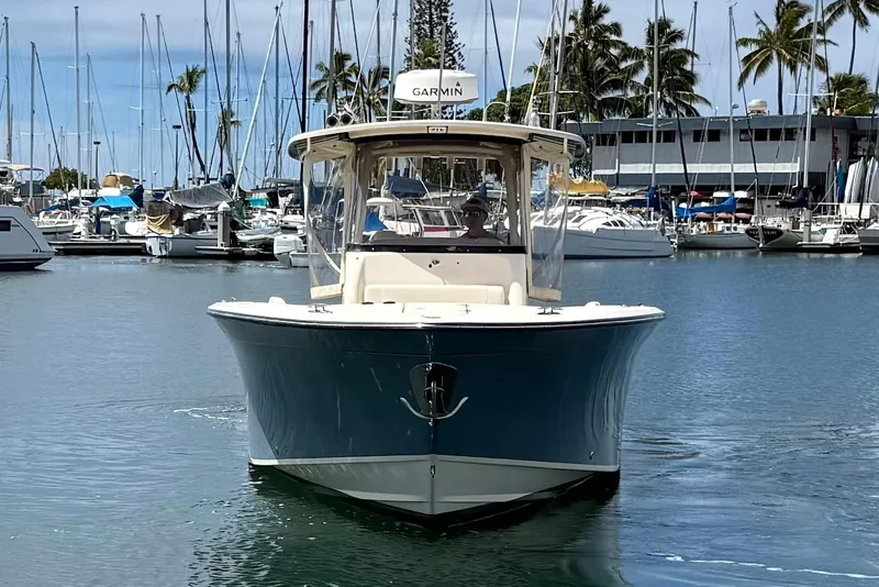 Slide: The Image of 2020 Grady-White Canyon 306 boat in marina, surrounded by sailboats and palm trees. - 3