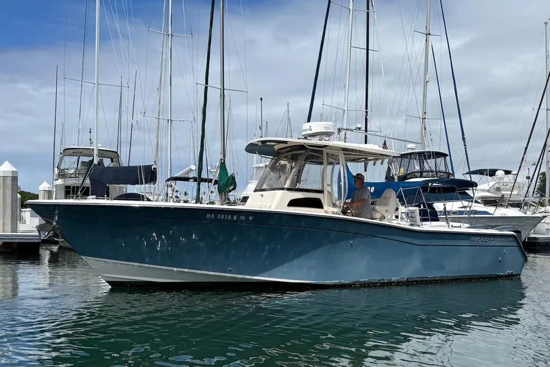 Slide: The Image of 2020 Grady-White Canyon 306 boat docked at marina, calm water, overcast sky. - 4