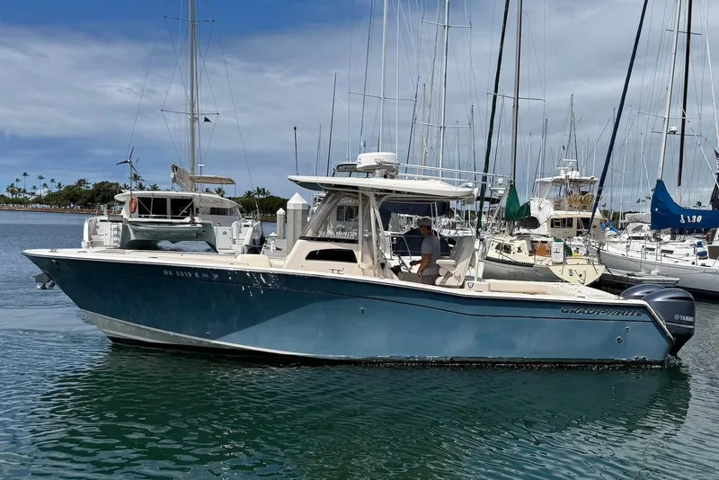 Slide: The Image of 2020 Grady-White Canyon 306 boat docked in a marina with clear skies. - 5