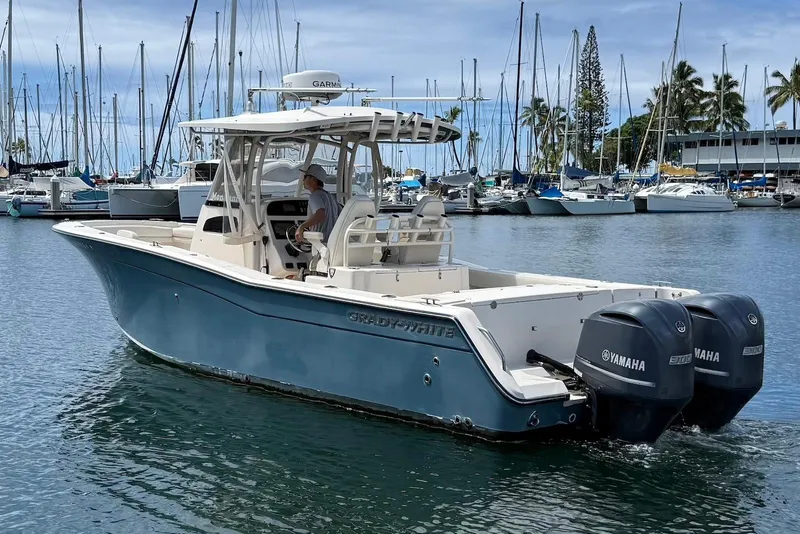 Slide: The Image of 2020 Grady-White Canyon 306 boat with twin Yamaha engines in a marina setting. - 6