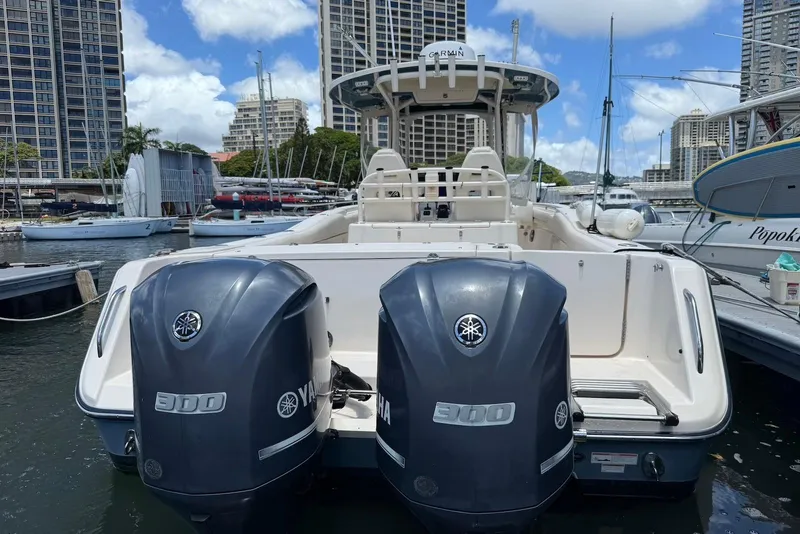 Slide: The Image of 2020 Grady-White Canyon 306 boat with twin Yamaha 300 engines docked in a marina. - 7