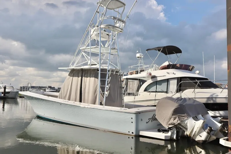 Slide: The Image of 2015 Regulator 34 boat docked at marina under cloudy sky. - 10
