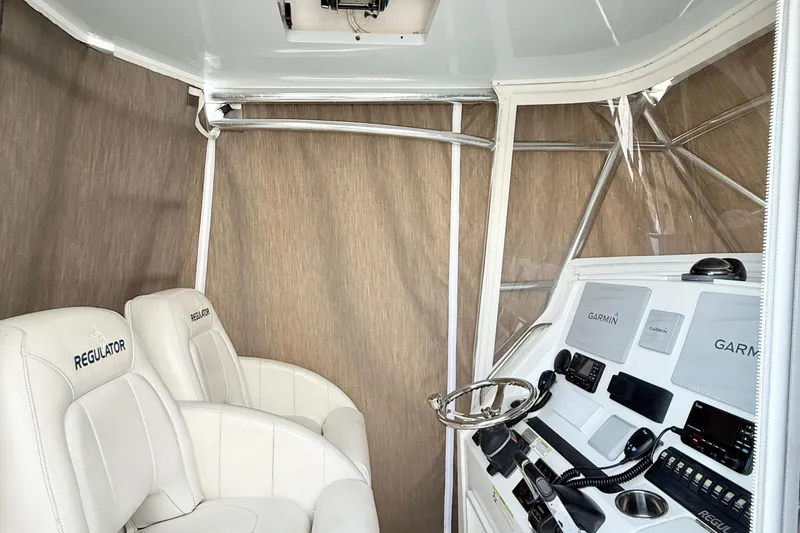 Slide: The Image of 2015 Regulator 34 boat interior with Garmin navigation system and white seating. - 12