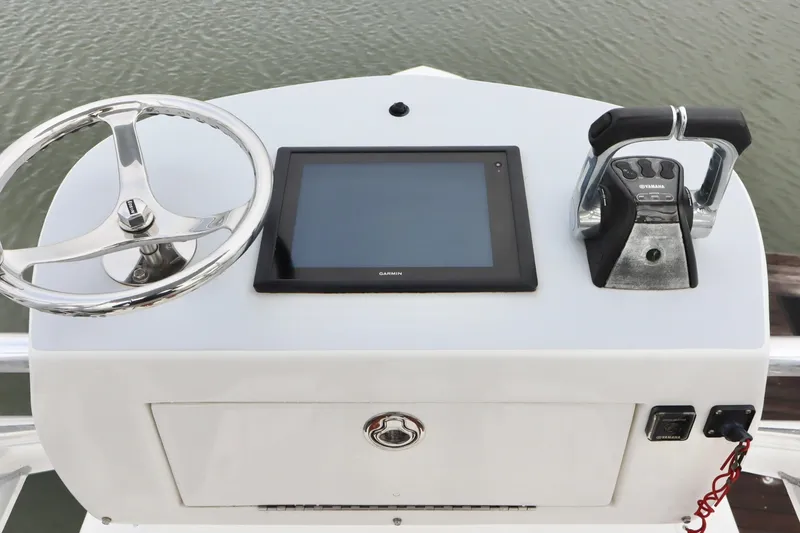 Slide: The Image of Control panel of a 2015 Regulator 34 boat with steering wheel and Garmin display. - 17