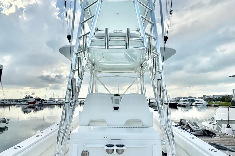 Slide: The Image of 2015 Regulator 34 boat with tower, docked in a marina under cloudy skies. - 18