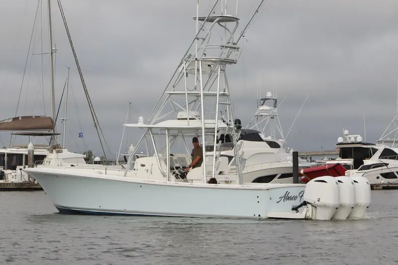 Slide: The Image of 2015 Regulator 34 boat docked in marina with overcast sky. - 4