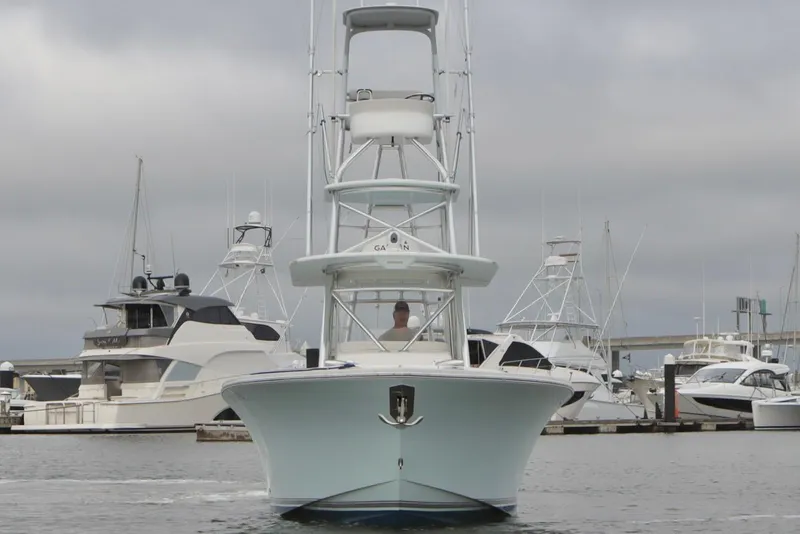 Slide: The Image of 2015 Regulator 34 boat docked at marina with other yachts in background. - 6