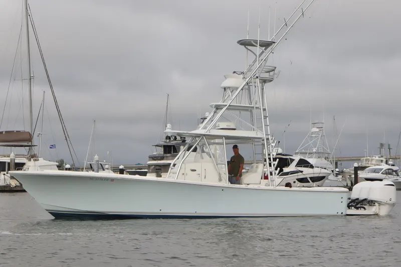 Slide: The Image of 2015 Regulator 34 boat docked in a marina with overcast skies. - 8