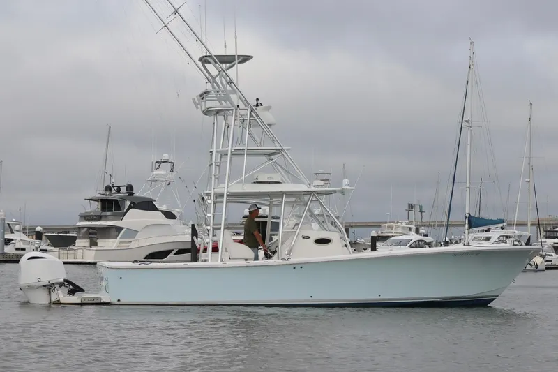 Slide: The Image of 2015 Regulator 34 boat docked in a marina with overcast skies. - 9