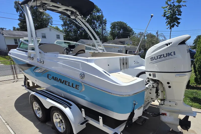 Slide: The Image of 2021 Caravelle 19 EBo Bowrider boat with Suzuki outboard motor on trailer. - 10
