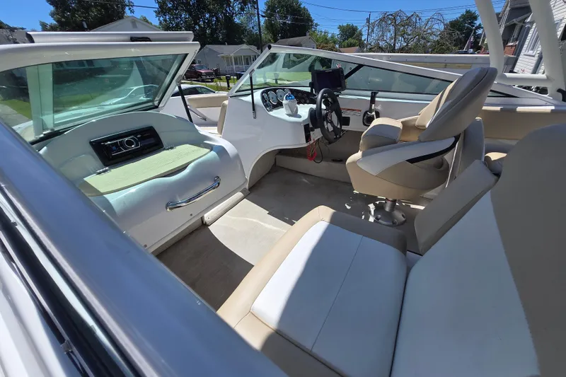 Slide: The Image of 2021 Caravelle 19 EBo Bowrider interior with beige seating and modern dashboard. - 11
