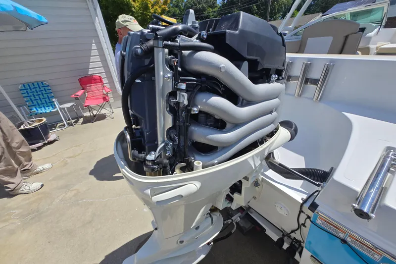 Slide: The Image of 2021 Caravelle 19 EBo Bowrider with exposed engine, parked outdoors. - 13