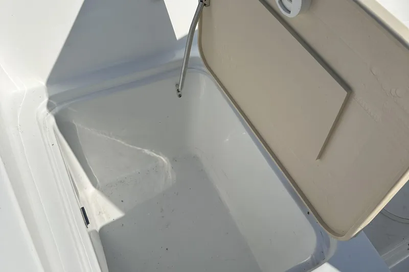 Slide: The Image of Open storage compartment in 2021 Caravelle 19 EBo Bowrider boat. - 15