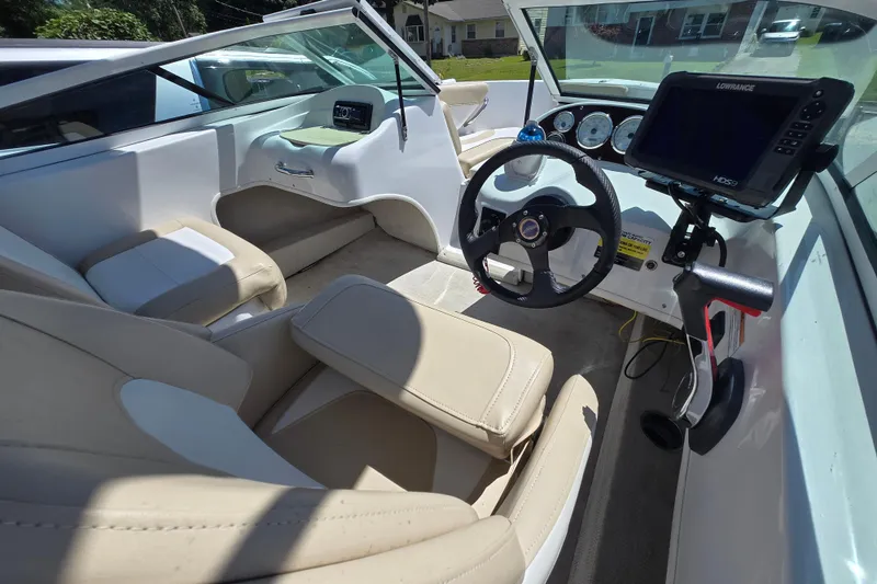 Slide: The Image of Interior of a 2021 Caravelle 19 EBo Bowrider boat with steering wheel and navigation system. - 5