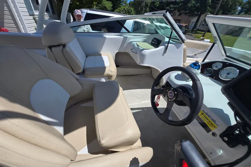 Slide: The Image of 2021 Caravelle 19 EBo Bowrider interior with beige seating and modern dashboard. - 6