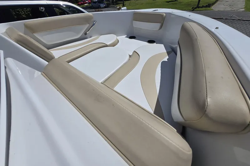 Slide: The Image of 2021 Caravelle 19 EBo Bowrider interior with beige seating and white accents. - 7