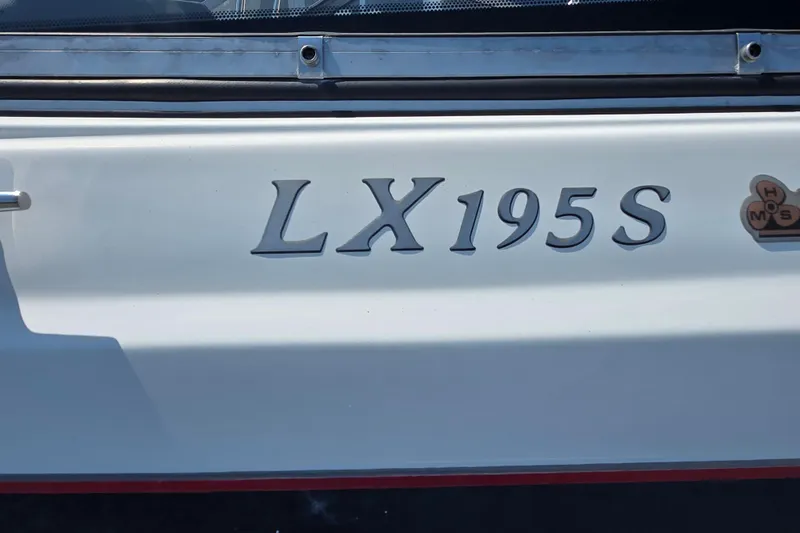 Slide: The Image of 2014 Larson LX 195S IO boat model nameplate on white surface. - 12