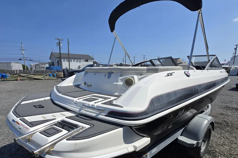 Slide: The Image of 2014 Larson LX 195S IO boat on trailer, featuring sleek design and black accents. - 7