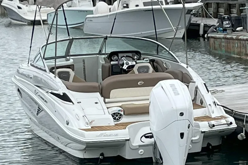 Slide: The Image of 2023 Crownline Eclipse E235 XS boat docked in a marina. - 10