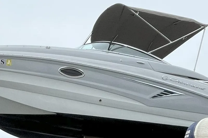 Slide: The Image of 2023 Crownline Eclipse E235 XS boat with canopy, side view. - 11