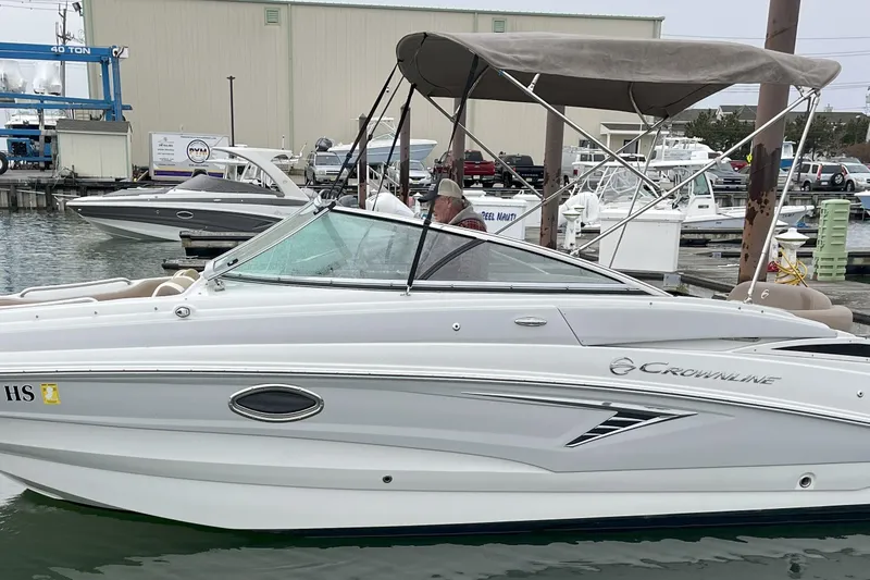 Slide: The Image of 2023 Crownline Eclipse E235 XS boat docked at marina with canopy. - 8