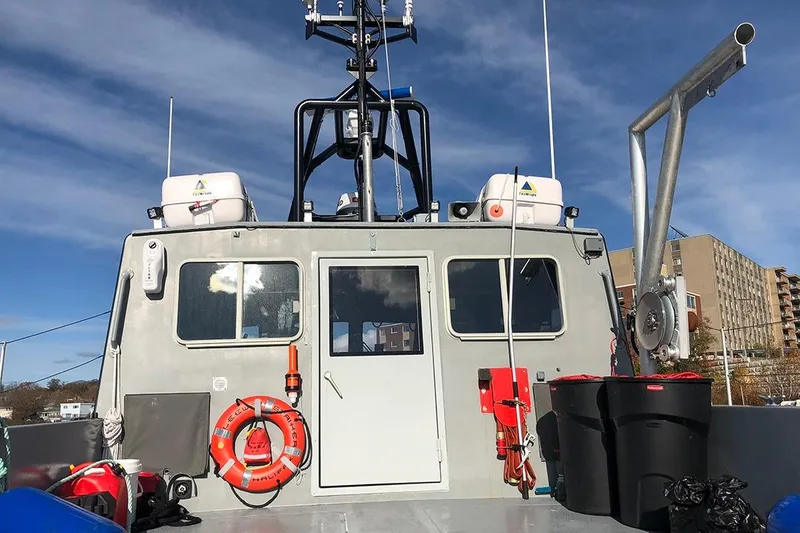 Slide: The Image of River Hawk 73 Sea Stryker Fast Patrol Boat, 2012, docked with safety equipment visible. - 10