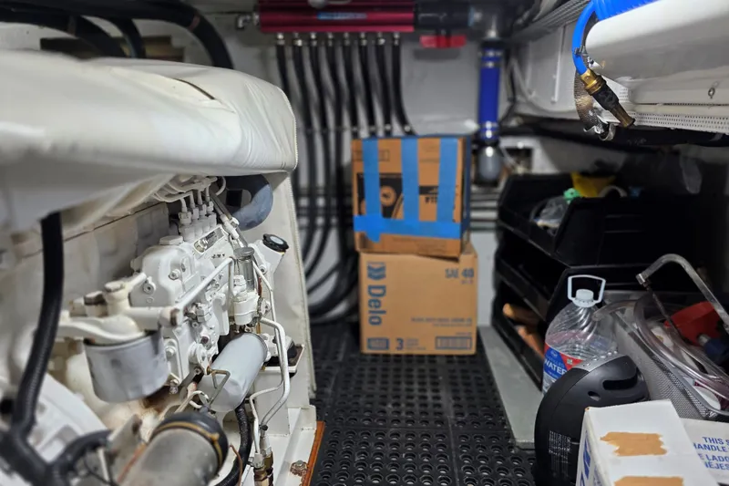 Slide: The Image of Engine room of a 1974 Chris-Craft Roamer with visible machinery and storage items. - 10
