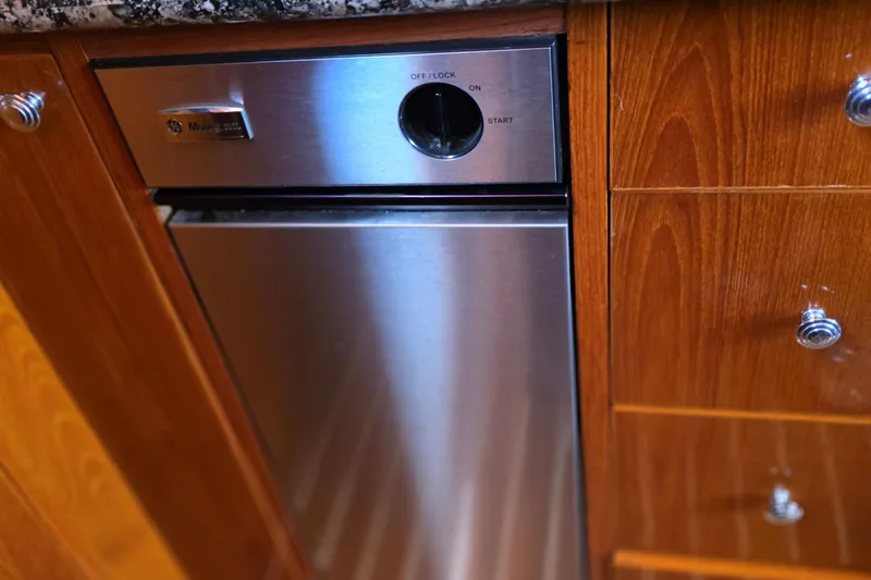 Slide: The Image of 1974 Chris-Craft Roamer kitchen with stainless steel appliance and wooden cabinetry. - 5