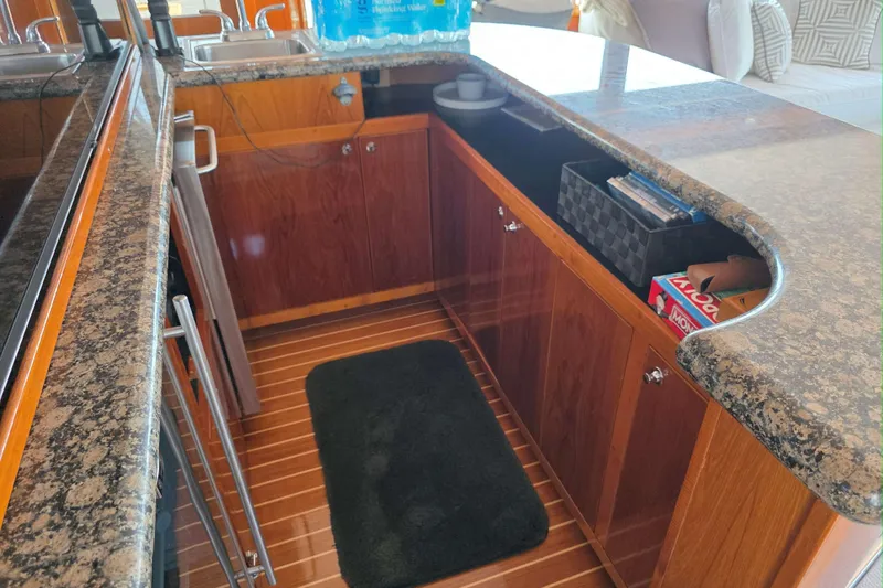 Slide: The Image of 1974 Chris-Craft Roamer yacht interior with granite countertops and wooden cabinetry. - 7