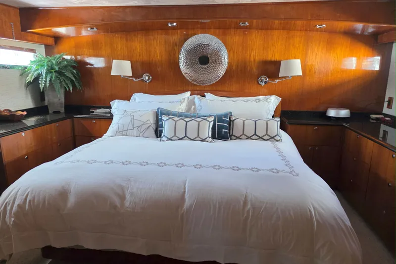 Slide: The Image of Luxurious bedroom interior of a 1974 Chris-Craft Roamer yacht with elegant wood paneling. - 9