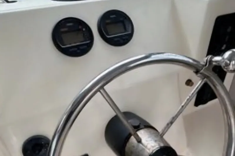Slide: The Image of Steering wheel and gauges of a 2001 Parker 2520 Modified Vee Sport Cabin boat. - 10