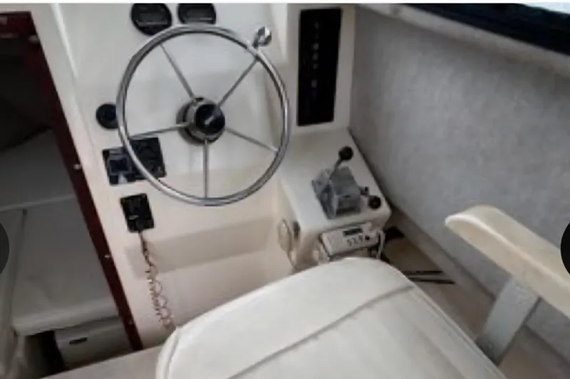 Slide: The Image of Interior helm of 2001 Parker 2520 Modified Vee Sport Cabin with steering wheel and controls. - 13