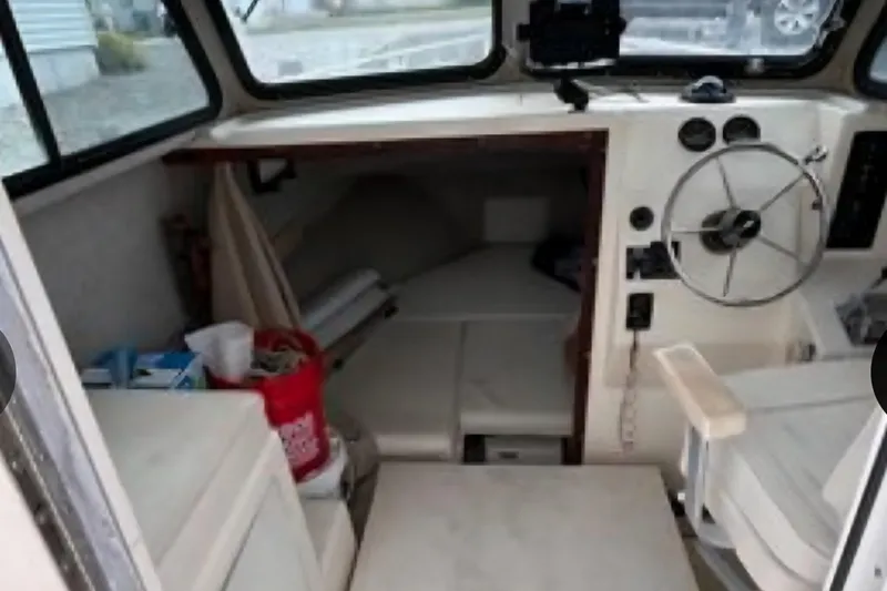 Slide: The Image of 2001 Parker 2520 Modified Vee Sport Cabin interior with steering wheel and cabin space. - 14