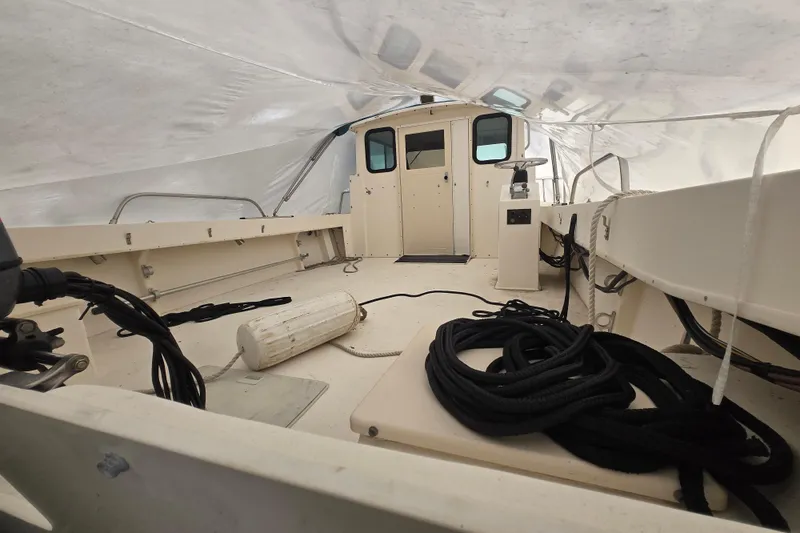 Slide: The Image of 2001 Parker 2520 Modified Vee Sport Cabin boat interior under protective cover. - 15